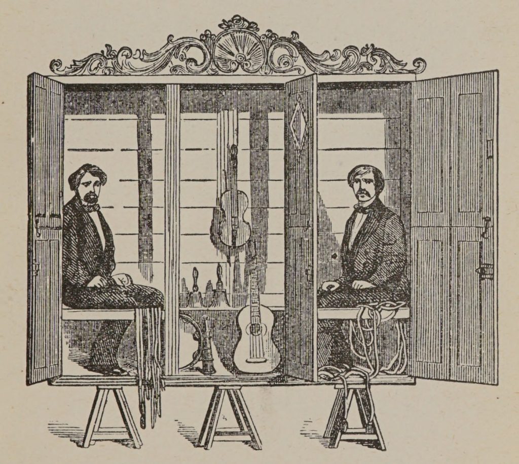 Los hermanos Davenport, en el armario que utilizaban en su espectáculo espiritista. Ilustración: Henry Ridgely Evans