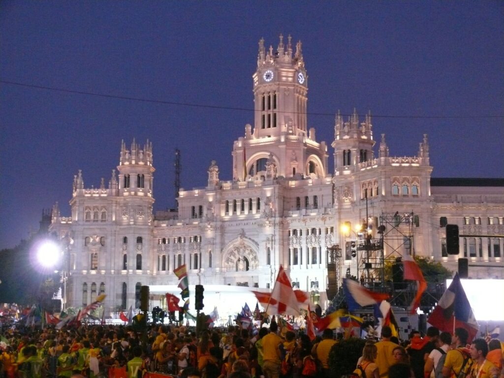 Un cartel contra la visita de Benedicto XVI, en una asamblea de integrantes del movimiento de los 'indignados' en Madrid. Foto: Efe. Misa de apertura de la Jornada Mundial de la Juventud 2011 en la plaza de Cibeles de Madrid. Foto: Peter Potrowl.